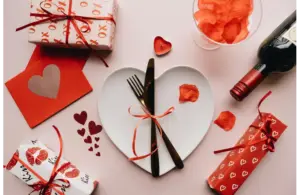 valentine dinner table with heart shaped plate and small red gifts