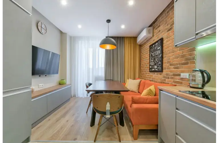 a small living area beautifully decored with sofas and curtains.