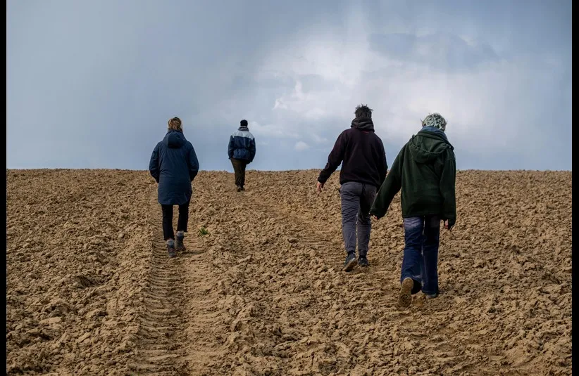 In daily devotion, four men are walking.