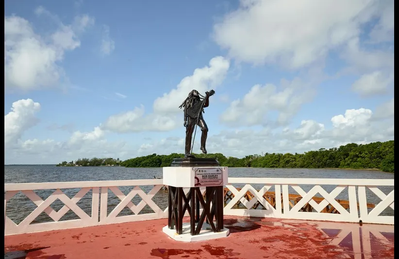 In black history today, a fiuge of Bob Marley is seen in background.