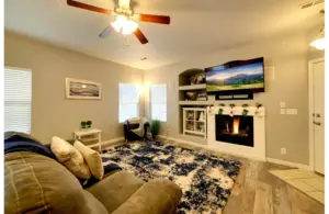 a beautiful living area with a simple and decent mantel decor