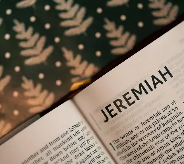 In daily devotion, a Bible is open to Jeremiah.