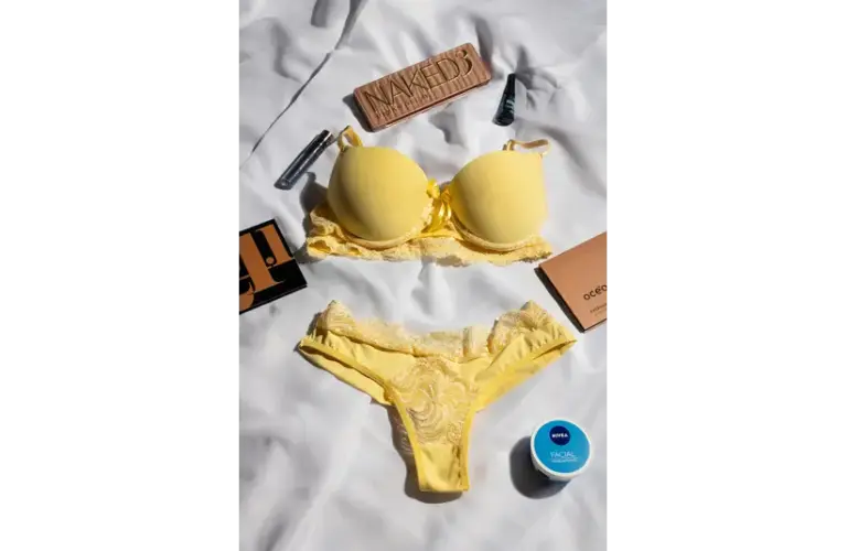 a yellow color lingerie with some makeup products