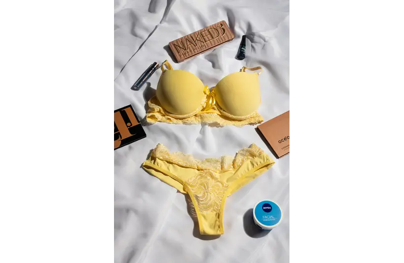a yellow color lingerie with some makeup products