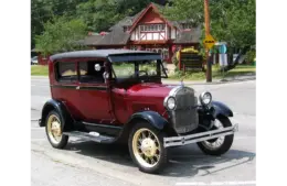 A red 1928 Model A Ford in front of Bowen Island Public Library, owned by Dan C. of Bowen Island.