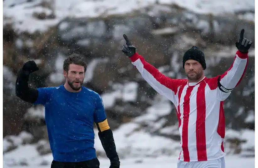 Image of Chris and Liam Hemsworth on top of a snowy mountain.