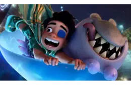 Characters from Disney Pixar "Elio" a boy and ginning shark alien falling through the sky