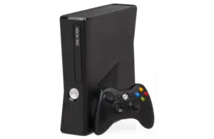 Black Xbox 360 with black Xbox controller leaning against it
