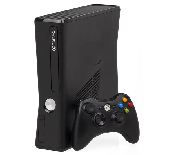 Black Xbox 360 with black Xbox controller leaning against it