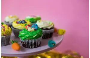 A tray of cute and bright Easter-themed cupcakes
