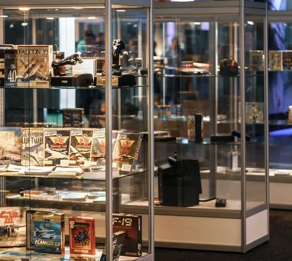 Three glasses cases with retro video games lining the shelves, Myrient