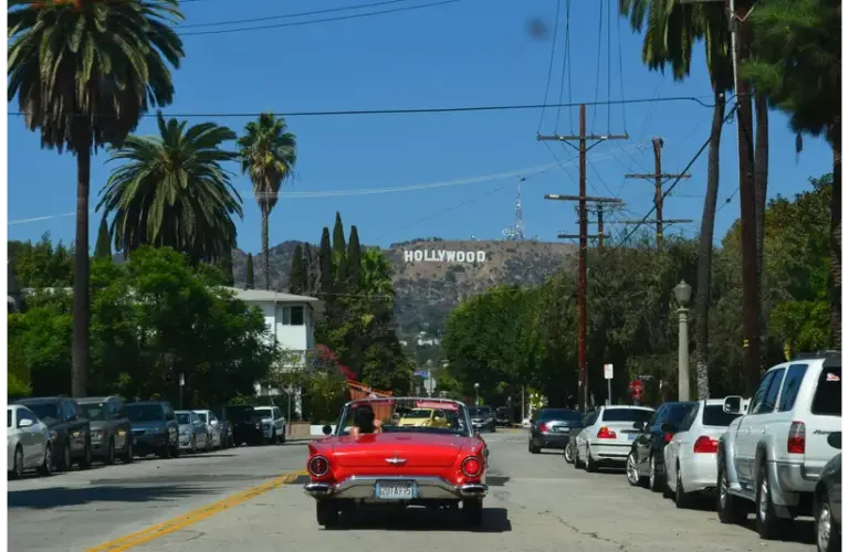 In today's daily Drop, the Hollywood sign is in the background with a red convertible driving towards it