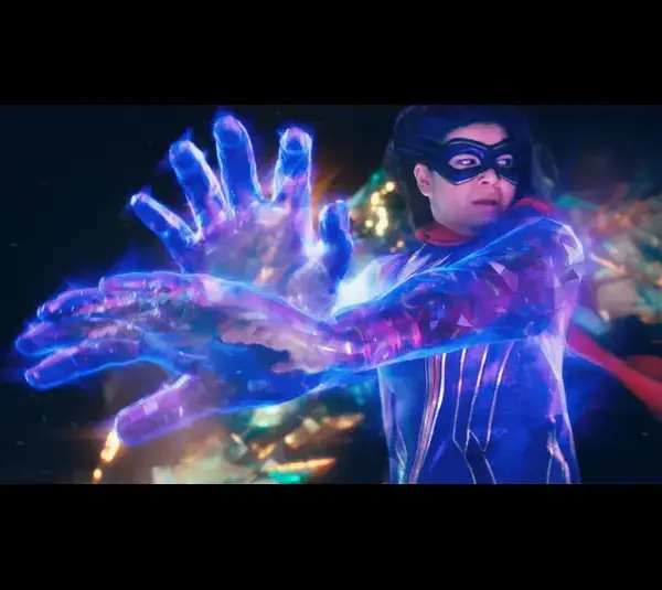 Kamala Khan as Ms. Marvel, with a flowing red cape harnessing energy, projecting large, glowing blue hands. The scene is dynamic and vibrant, exuding power.