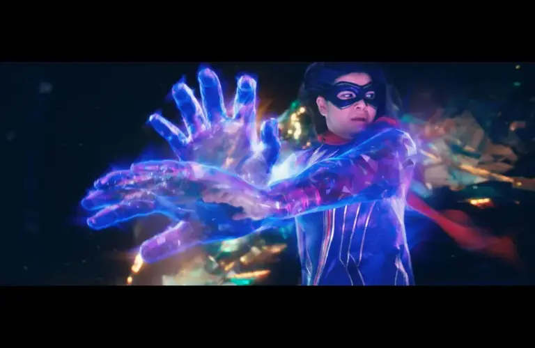 Kamala Khan as Ms. Marvel, with a flowing red cape harnessing energy, projecting large, glowing blue hands. The scene is dynamic and vibrant, exuding power.