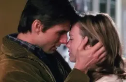 Jerry Maguire and Dorothy Boyd embrace tenderly, foreheads touching, eyes closed. The man gently holds her face, conveying a deep emotional connection and warmth.