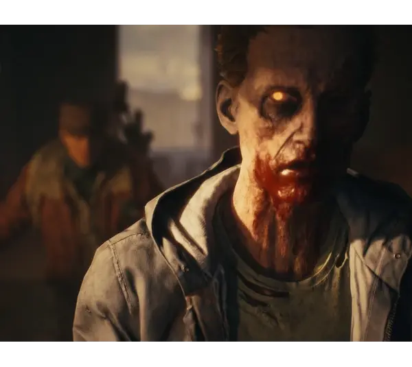 A menacing zombie in State of Decay 3 with glowing eyes and blood-stained mouth stands in dim lighting, conveying a haunting atmosphere. A blurry figure lurks in the background.