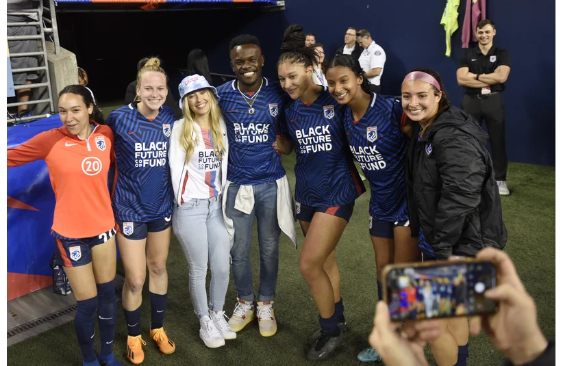 May 3, 2023; Seattle, Washington, USA; Members of the OL Reign pose for photos with love is blind contestants Kwame and Chelsea after the match against Angel City FC at Lumen Field. Mandatory Credit: Michael Thomas Shroyer-Imagn Images