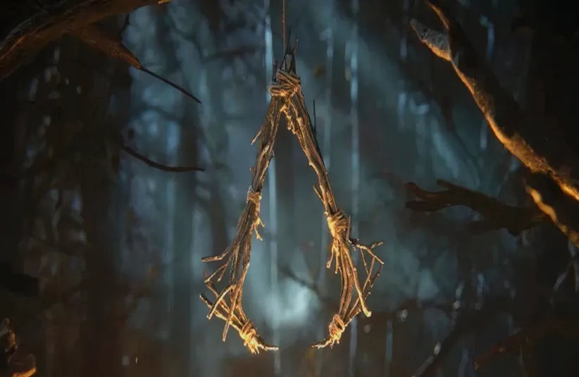image of a wood made Assassin's Insignia with a background of the woods for Assassin's Creed: Hexe