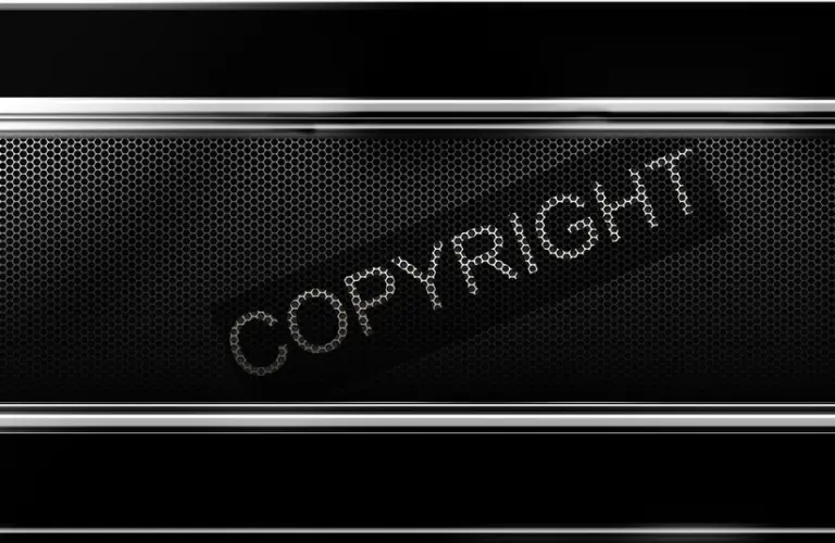 A metallic black background with a honeycomb pattern, featuring the word "COPYRIGHT" in bold, dotted letters tilted diagonally across the center.