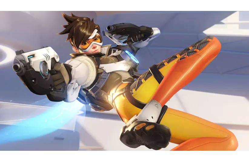 Tracer from Overwatch in a dynamic pose, wearing goggles and a futuristic outfit with orange leggings and holding two pistols. A blue light trail follows her.