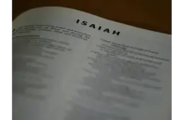 In daily devotion, a Bible is open to Isaiah.