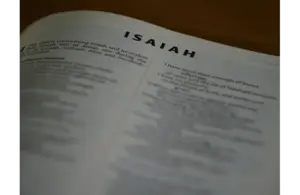 In daily devotion, a Bible is open to Isaiah.