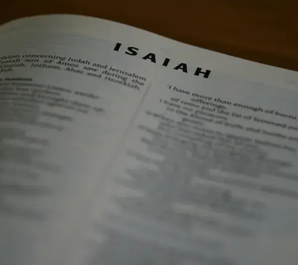 In daily devotion, a Bible is open to Isaiah.