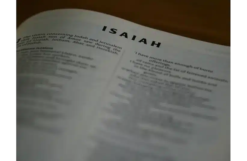 In daily devotion, a Bible is open to Isaiah.