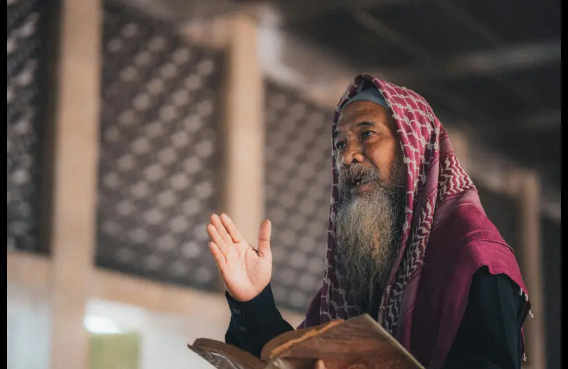 In daily devotion, a religious leader teaches a lesson. 