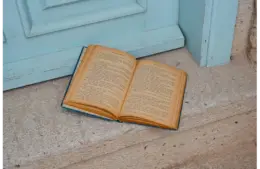 In daily devotional, an open Bible sits by a door.