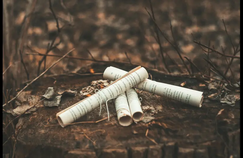 In daily devotional, scrolls are shown in the background, such as what John used to write Revelation.  