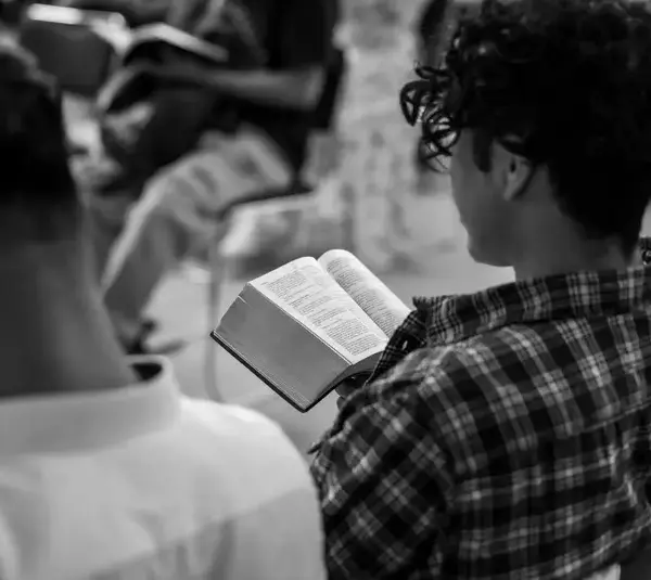 In this daily devotional, young people sit in a Bible study class.