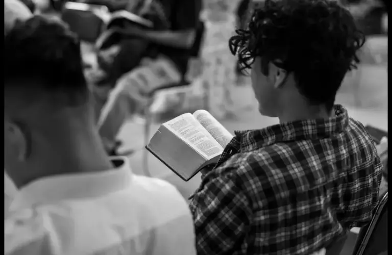 In this daily devotional, young people sit in a Bible study class.