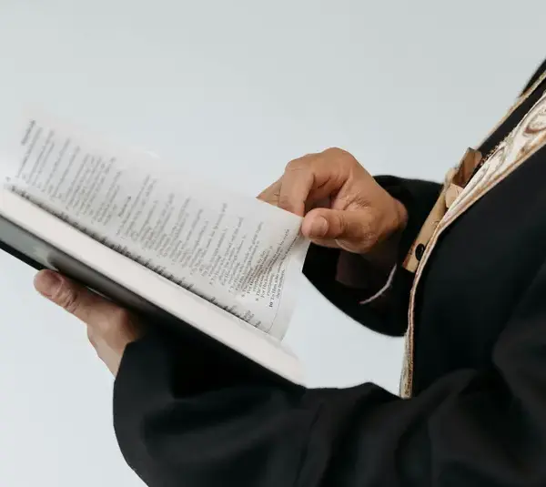 In daily devotional, a church officiant reads from the Bible.