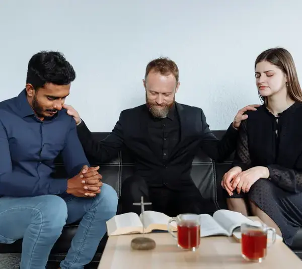 In the daily devotional, a priest prays for two people.