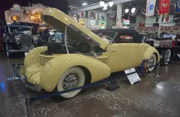 Yellow 1937 Cord 812 Supercharged Sportsman on display with the hood raised, Cord 812 Berline