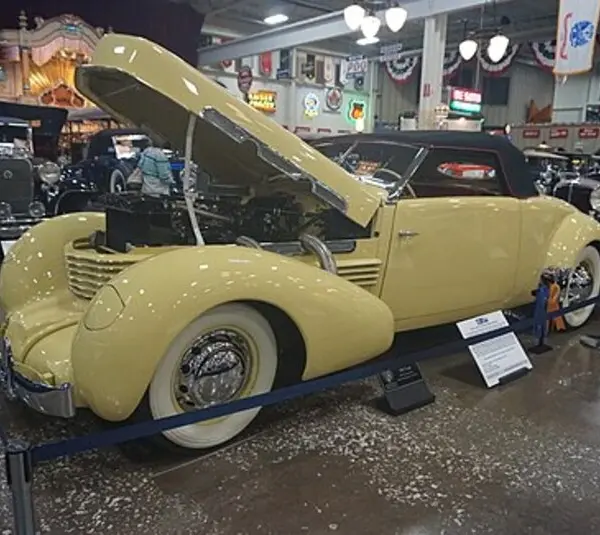 Yellow 1937 Cord 812 Supercharged Sportsman on display with the hood raised, Cord 812 Berline