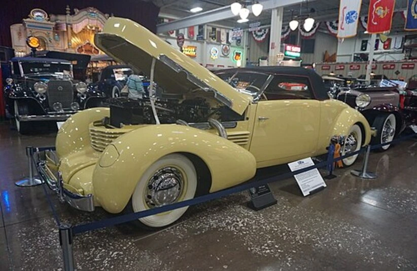 Yellow 1937 Cord 812 Supercharged Sportsman on display with the hood raised, Cord 812 Berline