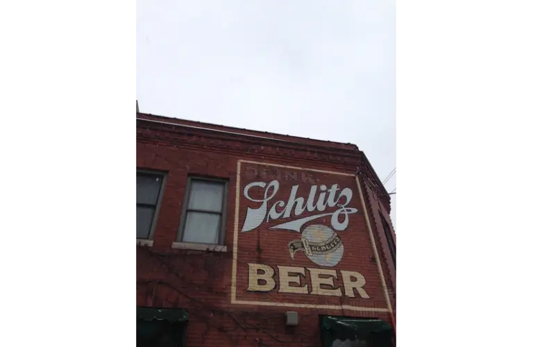 Old Schlitz Beer advertisement on a red brick building in Milwaukee Wisconsin