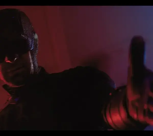 Daredevil, bathed in red and blue light reaches forward, conveying intensity and mystery. The atmosphere is dark and dramatic, highlighting action. (Daredevil Born Again)