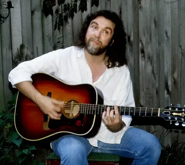 Nashville's Dennis Locorriere relaxes with his guitar outside his Oak Hill bungalow Aug. 29, 1990. The former Dr. Hook lead vocalist has been writing songs and singing jingles, trying to stay out of the limelight while he raised his son.
