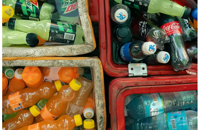 Vibrant photo of various custom sodas in outdoor coolers, perfect for a hot day