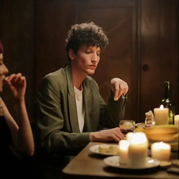 A couple enjoying romantic candlelit dinners in a cozy, Parisian-inspired setting filled with warm lighting and intimate charm.