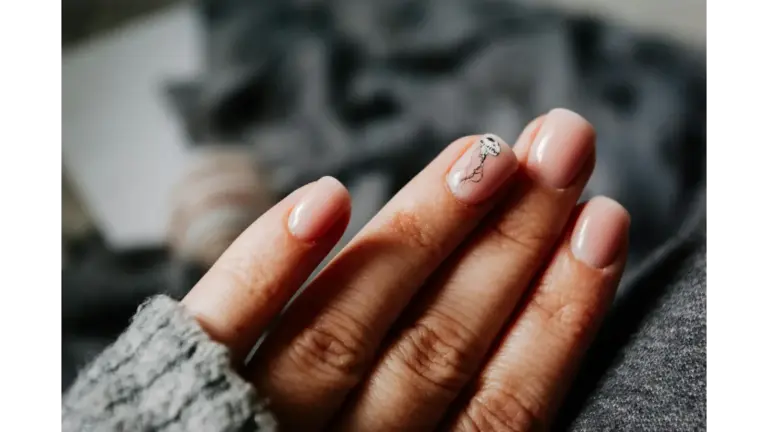 Close-up of a woman's elegant natural nails featuring a jellyfish design on soft pastel nails