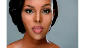 Close-up portrait of a woman with perfect makeup and expressive eyes showcasing the essence of sheer beauty on a smooth background.