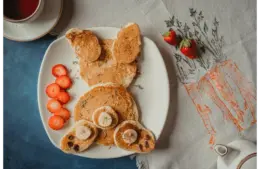 Adorable animal-shaped pancakes served with strawberries for a delightful creative breakfast