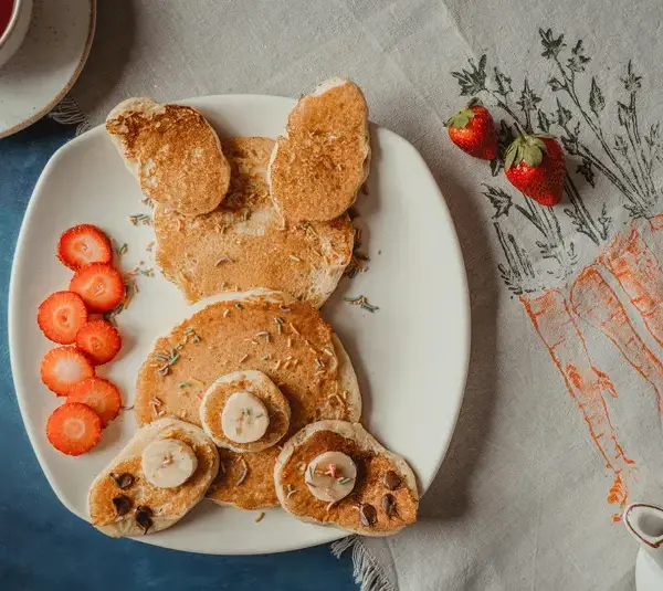 Adorable animal-shaped pancakes served with strawberries for a delightful creative breakfast