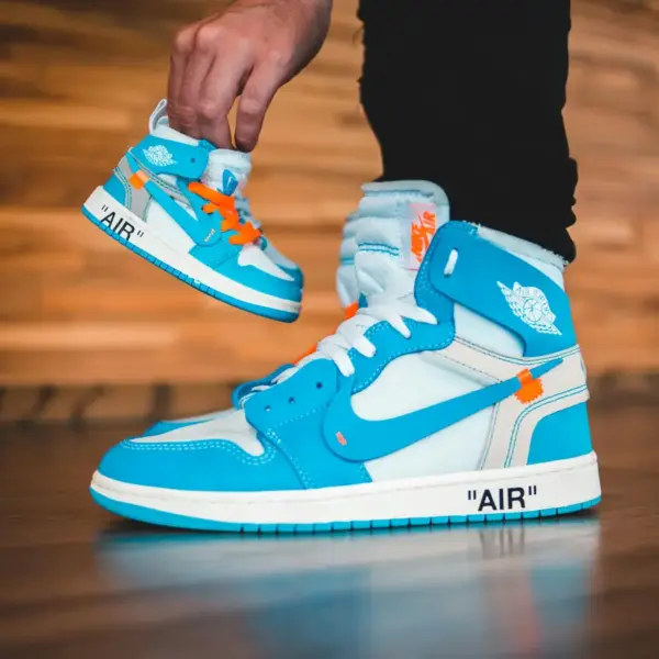 Bright blue sneakers with a smaller replica, showing trendy sneaker design indoors, highlighting modern style and strong jordan value for today’s collectors.