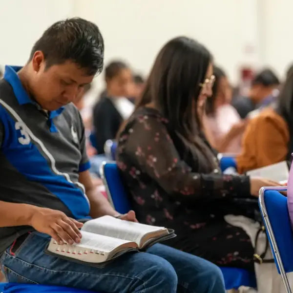 In daily devotional, people in a Bible school or class are studying the Bible.