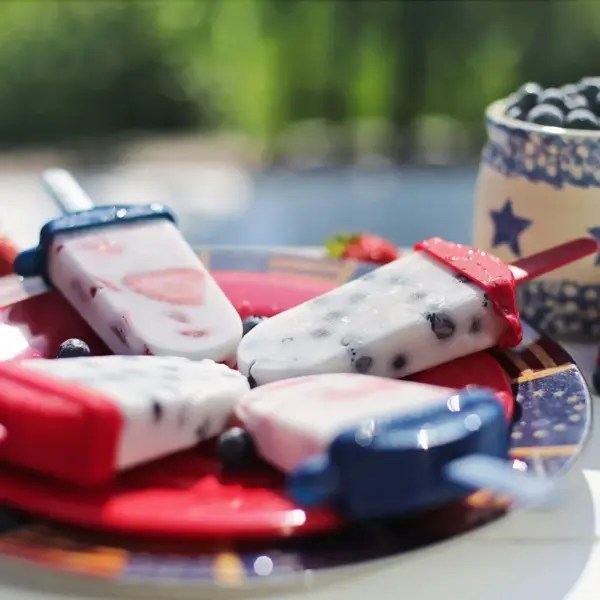 Ice cream treats with strawberries and blueberries pair beautifully with refreshing yogurt bites for a bright, fun dessert moment.